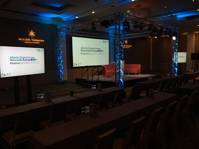 Truss Structure Surrounding Stage with Screens and Lighting