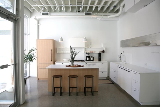 Fully functional kitchen with fridge/freezer, oven and stovetop, sink and dishwasher.