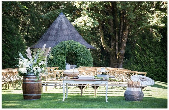 Outdoor ceremony with welcome table offering guests programs, hanky’s, lavender sachets and parasols.