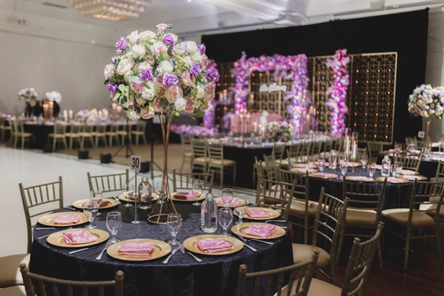 Gold Curved Piping Centerpiece, Gold Chivari Chairs, and Flower Arch.