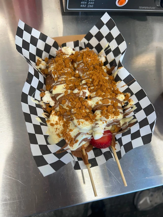 Golden waffle sticks topped with premium sauces and strawberries finished with Biscoff crumble.