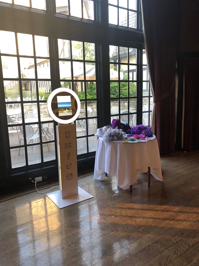 Our typical self-serve iPad photo booth setup with table of props & halo lighting..