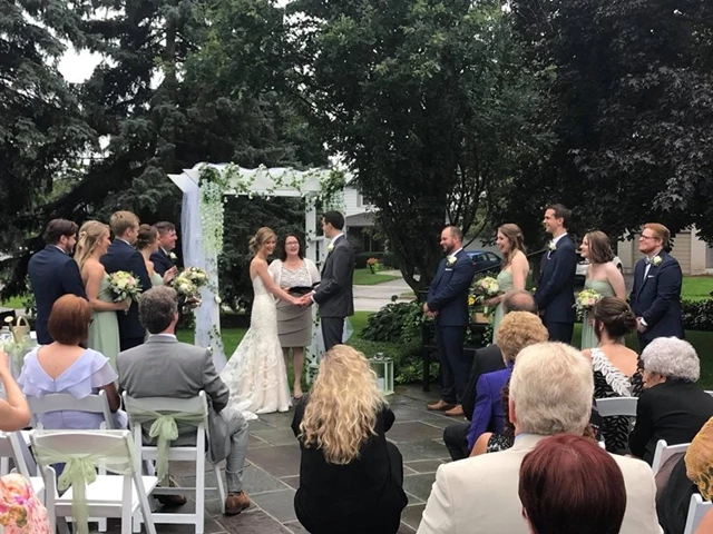Even a rainy delay is not enough to stop this lovely ceremony at Heintzman House.